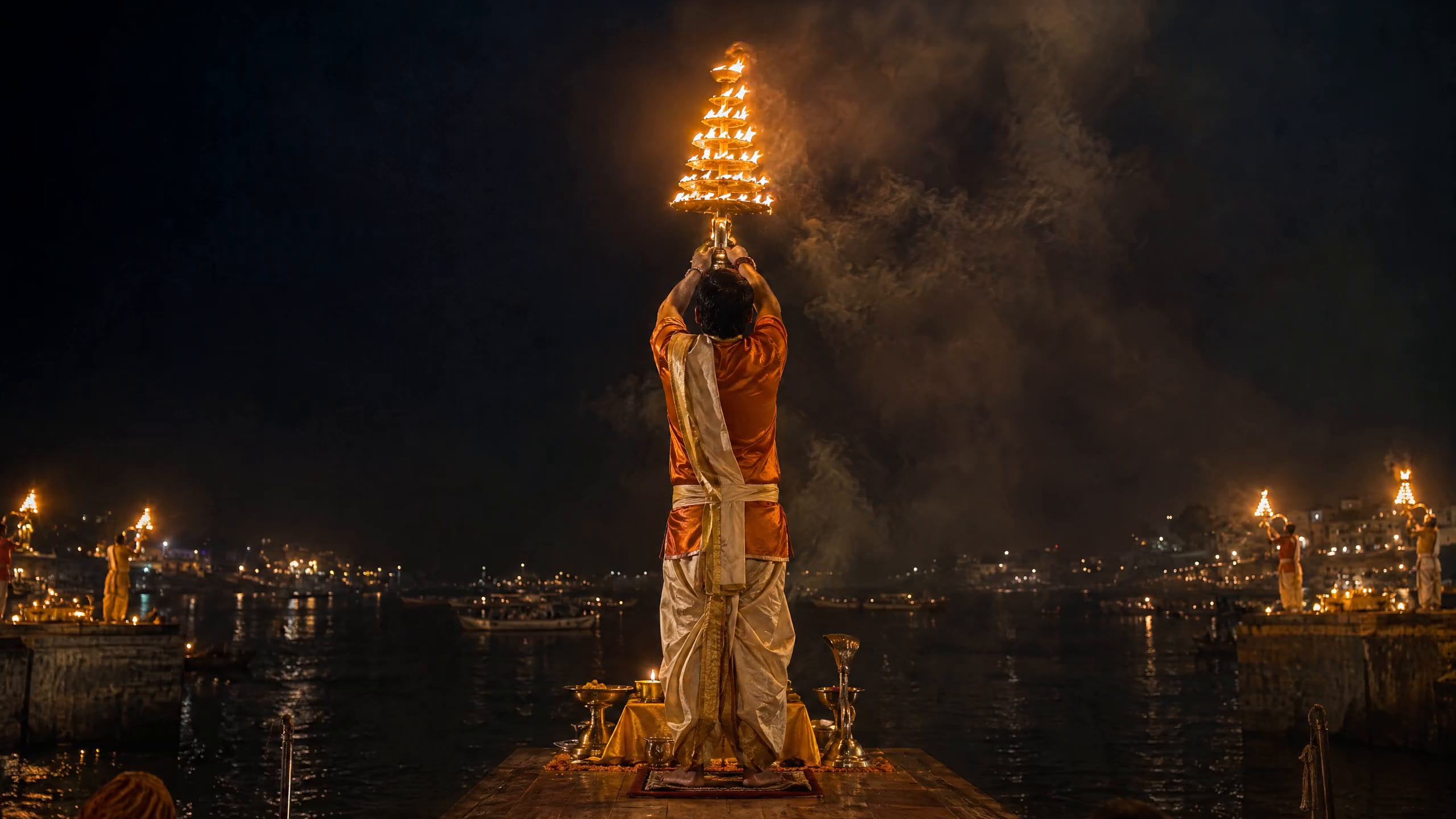 Evening Ganga aarti, tiered brass lamps blazing